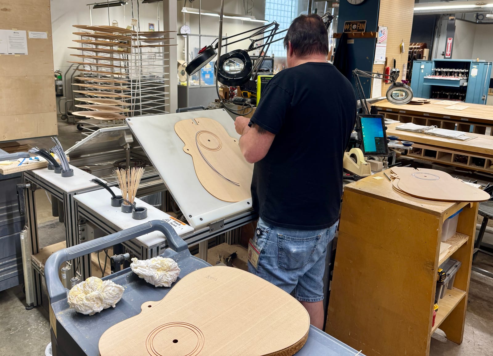 A Martin factory worker hand-inlaying a rosette around a soundhole